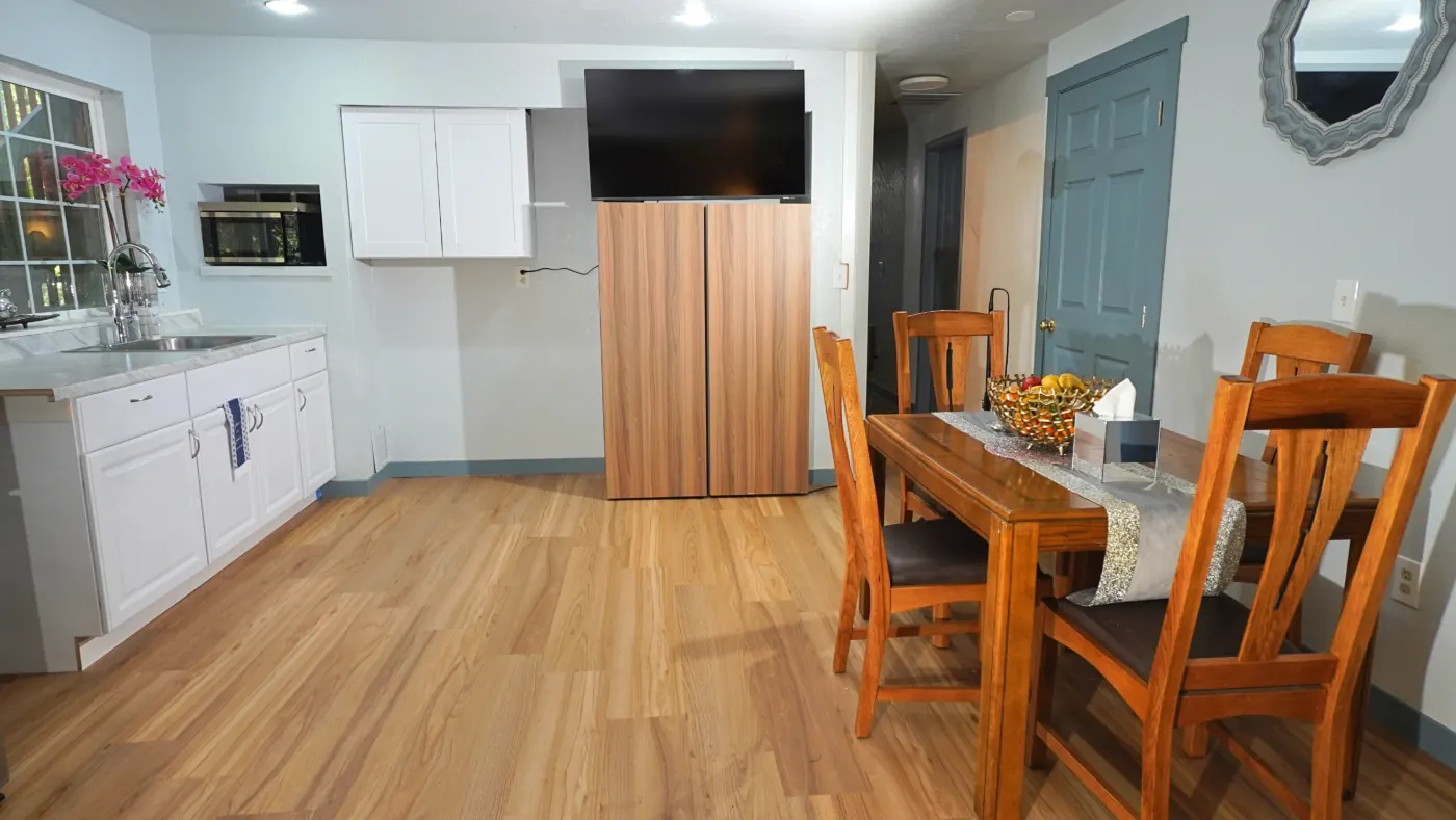 Open dining and kitchenette with hardwood floors
