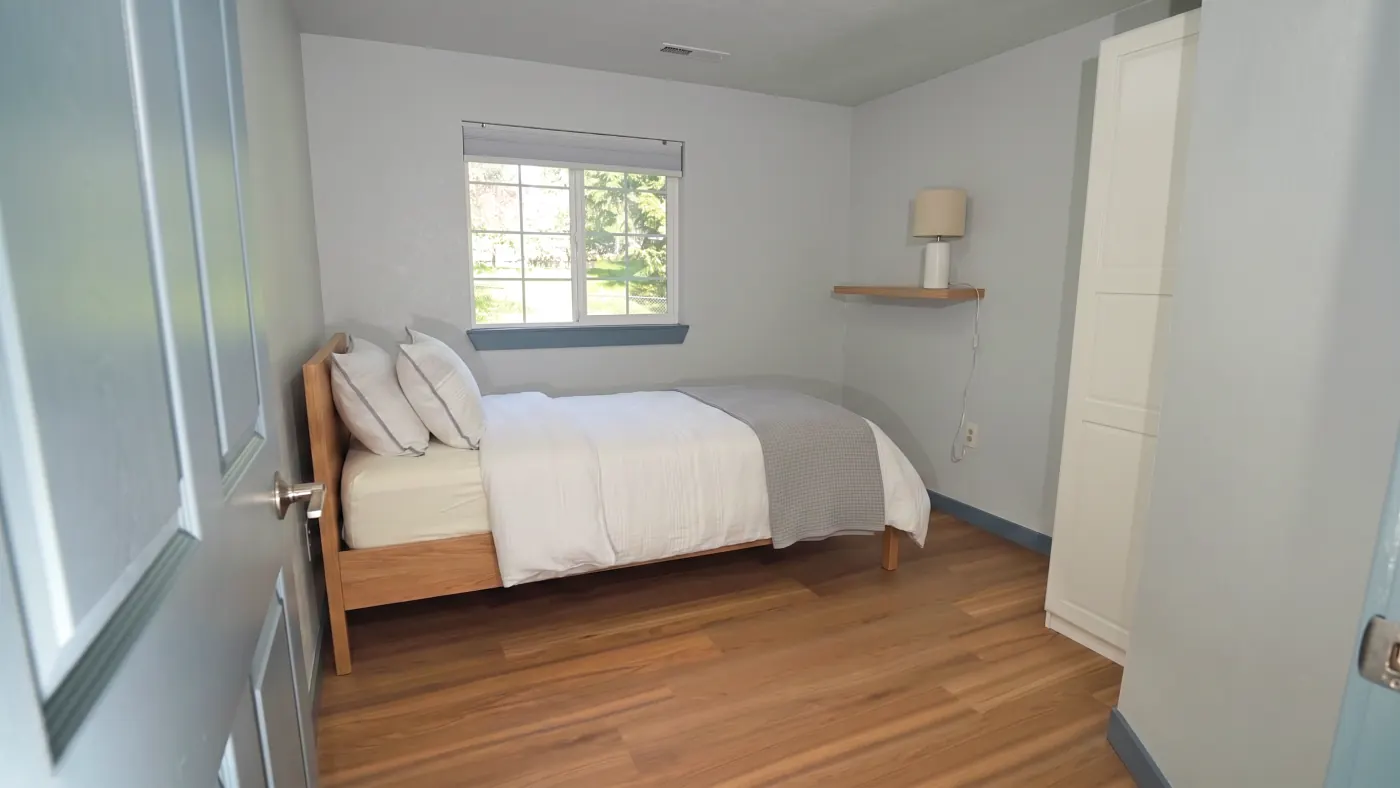 Comfortable bedroom with reading shelf and lamp