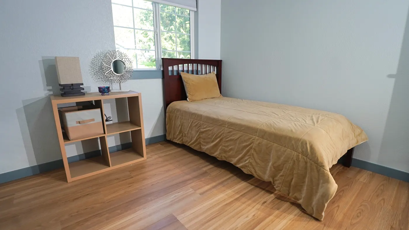 Restful bedroom with twin bed and decorative side shelf