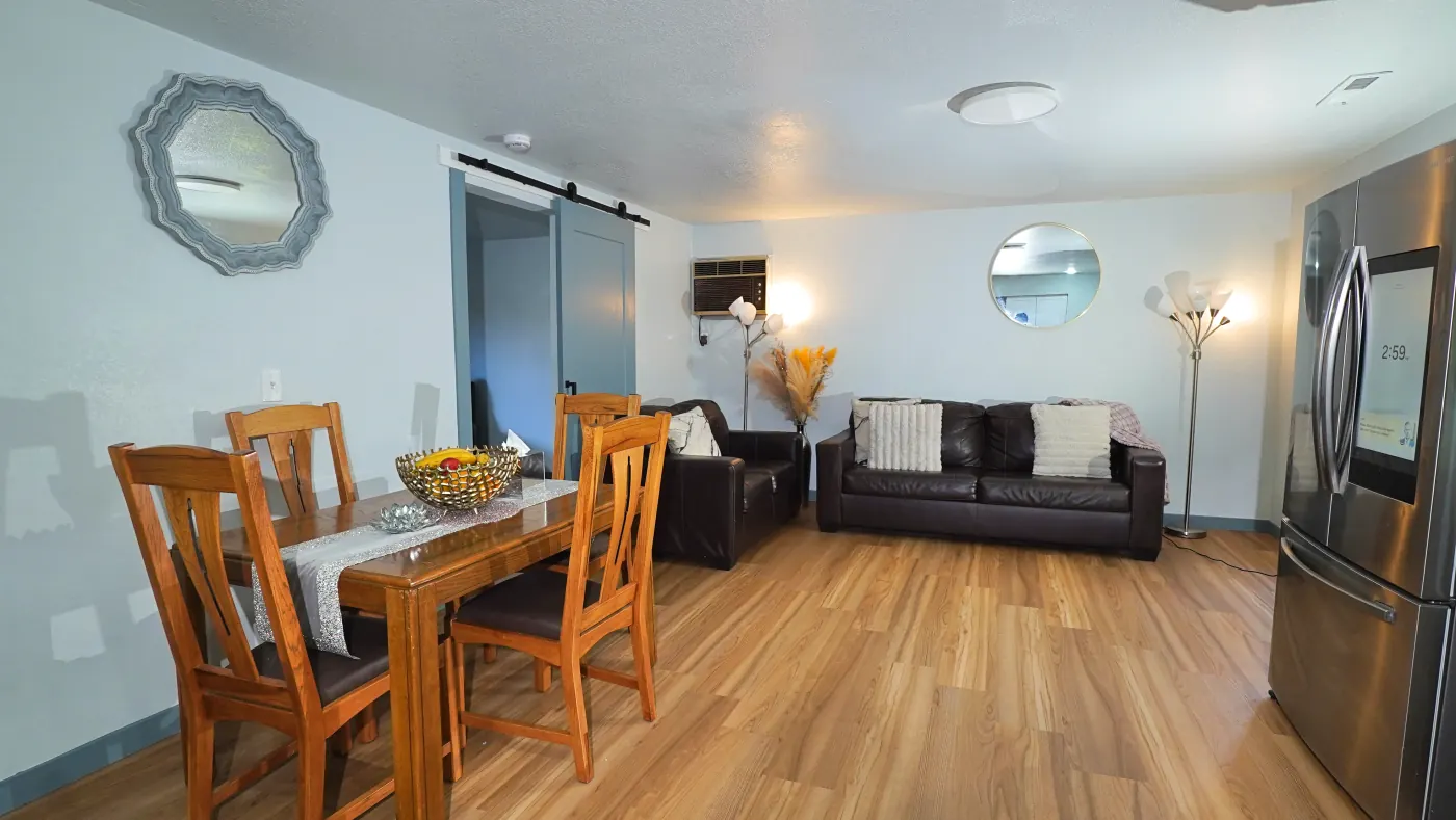 Open common area with dining table and lounge seating