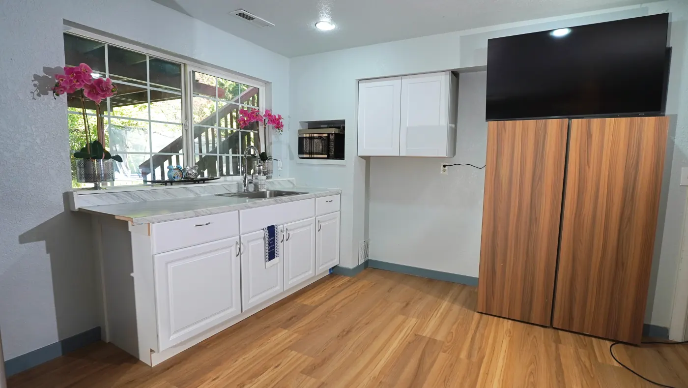 Kitchen with full-size fridge, microwave, and prep counter
