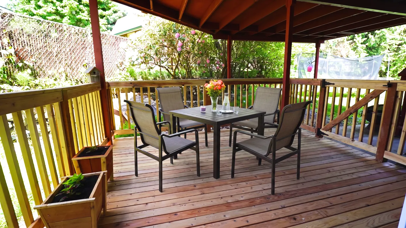 Covered outdoor patio with dining table and chairs